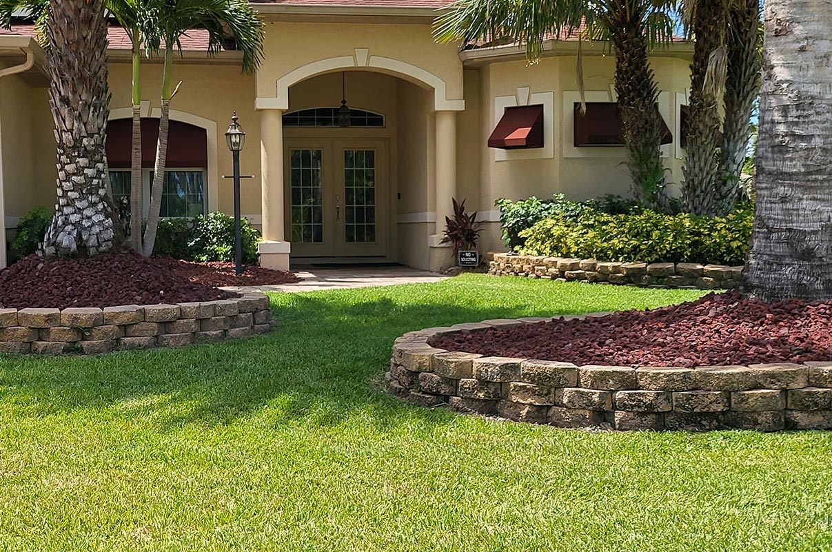 Shaded palm and mulch landscaping typical of mosquito season in Southwest Florida, where mosquitoes breed and hide